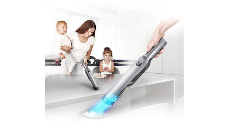 A view of the vacuum being used by a mom which has the unit on one hand while she's carrying a baby on her other arm A view of the vacuum being used by a mom which has the unit on one hand while she's carrying a baby on her other arm