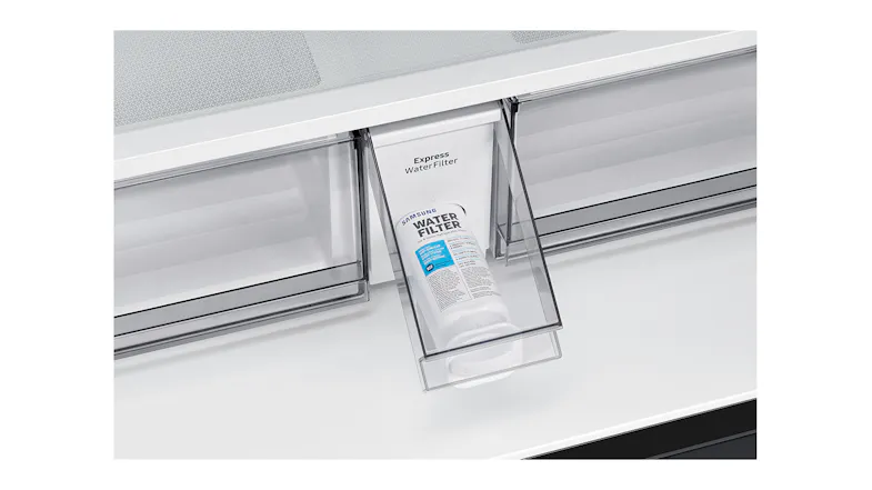 Front view of a white water filter inside a fridge pull-out drawer Front view of a white water filter inside a fridge pull-out drawer