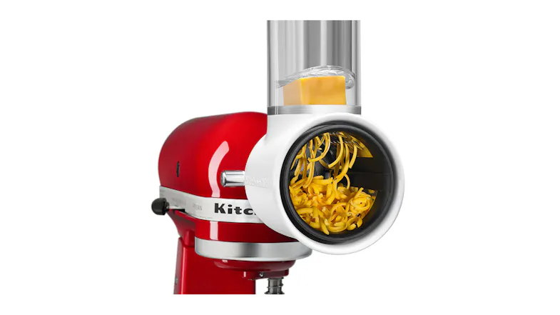 Close-up of a block of cheddar cheese being shredded through the fresh prep attachment Close-up of a block of cheddar cheese being shredded through the fresh prep attachment