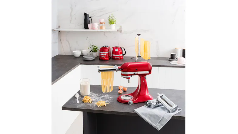 KitchenAid mixer on a modern kitchen island with flour, eggs, and freshly cut pasta ribbons KitchenAid mixer on a modern kitchen island with flour, eggs, and freshly cut pasta ribbons