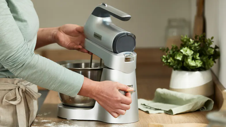 Person lifting the mixer head using the release lever on the Kenwood Chefette Combi stand Person lifting the mixer head using the release lever on the Kenwood Chefette Combi stand