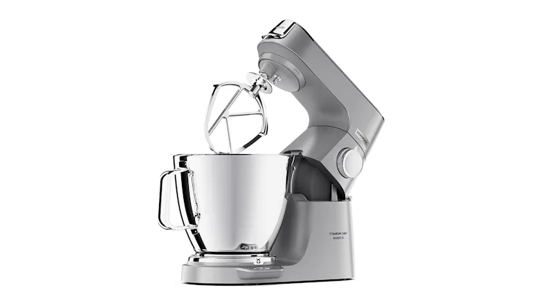 Kenwood Titanium Chef Baker XL with the head lifted and the K‑beater positioned above the stainless‑steel bowl Kenwood Titanium Chef Baker XL with the head lifted and the K‑beater positioned above the stainless‑steel bowl