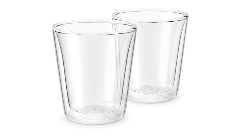 A front-view of two empty, clear double-walled glass cups placed side by side. A front-view of two empty, clear double-walled glass cups placed side by side.