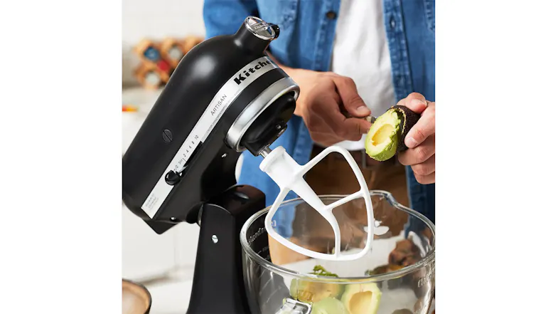 Person adding avocado halves to a KitchenAid glass bowl for mixing or mashing Person adding avocado halves to a KitchenAid glass bowl for mixing or mashing