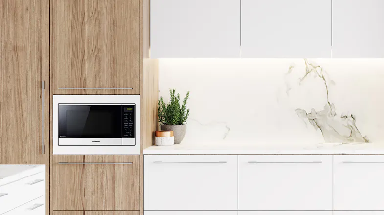 A flatbed inverter microwave with the door open on a kitchen counter A flatbed inverter microwave with the door open on a kitchen counter