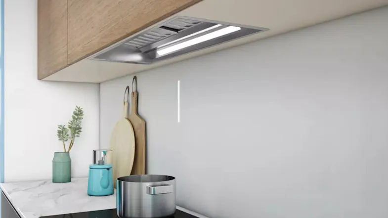 Sirius silver undermount rangehood installed beneath cabinetry above a cooktop Sirius silver undermount rangehood installed beneath cabinetry above a cooktop