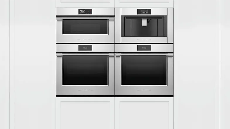 Four stacked kitchen appliances, one being a built-in coffee machine. Four stacked kitchen appliances, one being a built-in coffee machine.