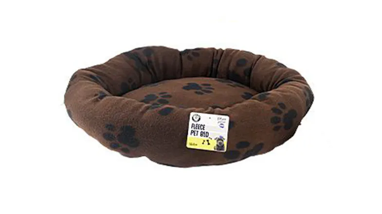 Round brown fleece pet bed with a padded rim and black paw print pattern Round brown fleece pet bed with a padded rim and black paw print pattern