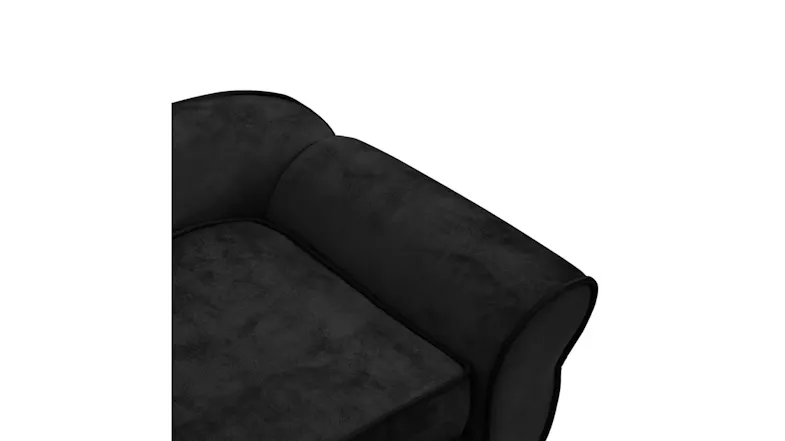 Close-up top view of the black dog sofa armrest and the soft bolster pillow texture Close-up top view of the black dog sofa armrest and the soft bolster pillow texture