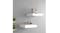 Two white floating shelves mounted on a wall and styled with decorative objects Two white floating shelves mounted on a wall and styled with decorative objects