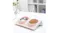 A pink dual pet feeding bowls placed on a white table with kibble in one bowl, shown in a clean home setting with decorations A pink dual pet feeding bowls placed on a white table with kibble in one bowl, shown in a clean home setting with decorations