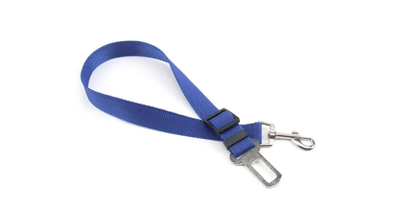 A blue adjustable dog harness made of durable nylon with a silver metal clip and car seatbelt buckle. A blue adjustable dog harness made of durable nylon with a silver metal clip and car seatbelt buckle.