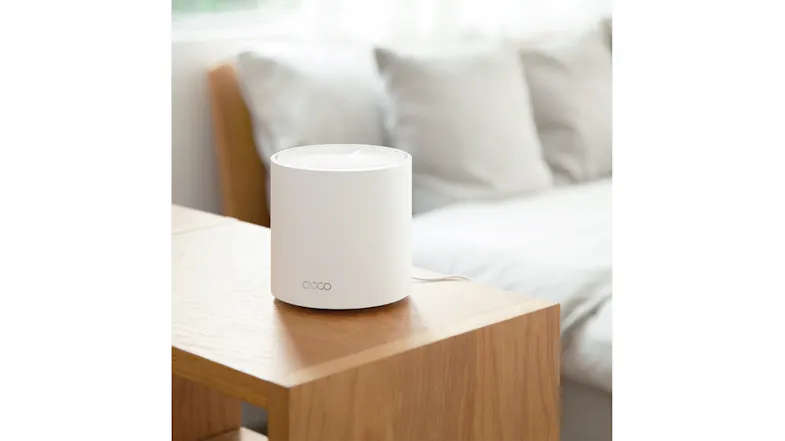 A Deco router sitting on a wood surface, blending into a home environment. A Deco router sitting on a wood surface, blending into a home environment.