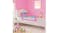 A pink NNEVL toddler safety rail installed on a white bed in a colourful child's bedroom A pink NNEVL toddler safety rail installed on a white bed in a colourful child's bedroom