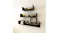 Three floating shelves holding books, jars, and decor Three floating shelves holding books, jars, and decor