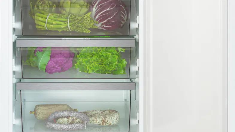 Close-up of fridge drawers storing asparagus, radicchio, cauliflower, lettuce, and cured meats Close-up of fridge drawers storing asparagus, radicchio, cauliflower, lettuce, and cured meats