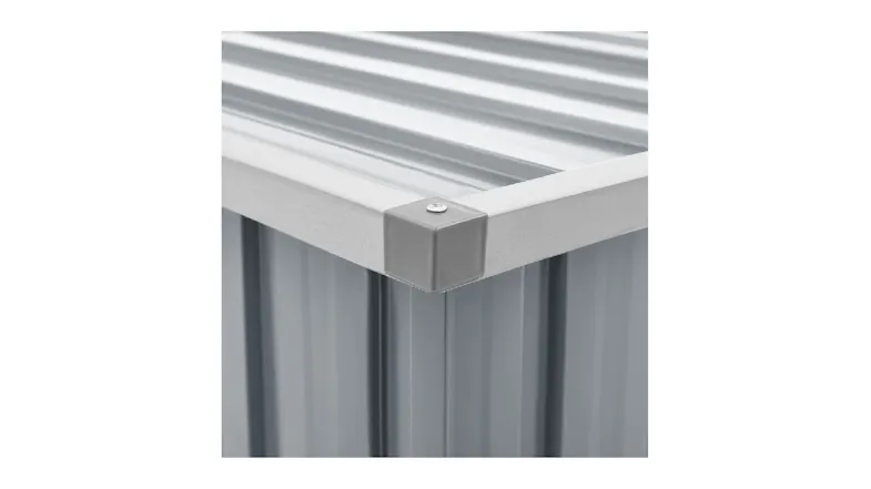 Close‑up of a top corner showing the metal lid’s ridged surface and a protective capped edge with a screw Close‑up of a top corner showing the metal lid’s ridged surface and a protective capped edge with a screw