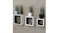 Three white square NNEVL wall shelves with black interiors, holding plants, a bicycle figurine, and a phone Three white square NNEVL wall shelves with black interiors, holding plants, a bicycle figurine, and a phone