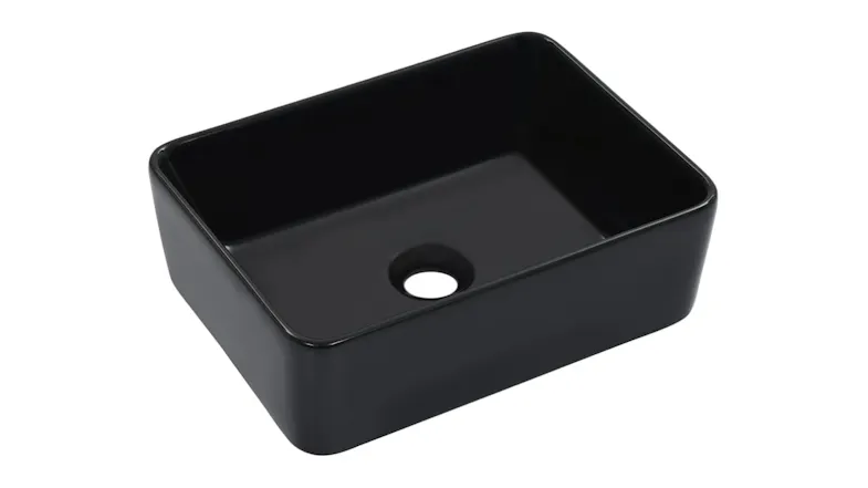 Angled view of the NNEVL rounded rectangular glossy black ceramic vessel sink with rounded corners and a centred drain hole Angled view of the NNEVL rounded rectangular glossy black ceramic vessel sink with rounded corners and a centred drain hole