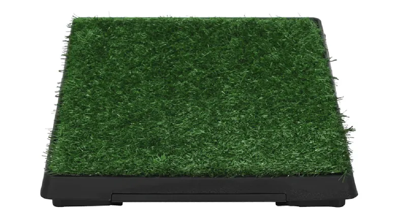 Front view of the pet toilet showing the green artificial grass mat on top of a black tray base Front view of the pet toilet showing the green artificial grass mat on top of a black tray base