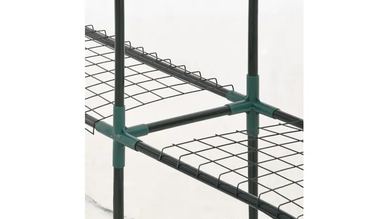 Close-up of a green metal NNEVL greenhouse frame and wire mesh shelving connected by plastic corner connectors Close-up of a green metal NNEVL greenhouse frame and wire mesh shelving connected by plastic corner connectors