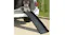 A dog using a black folding ramp to enter a car trunk, showing a non‑slip surface and sturdy design A dog using a black folding ramp to enter a car trunk, showing a non‑slip surface and sturdy design