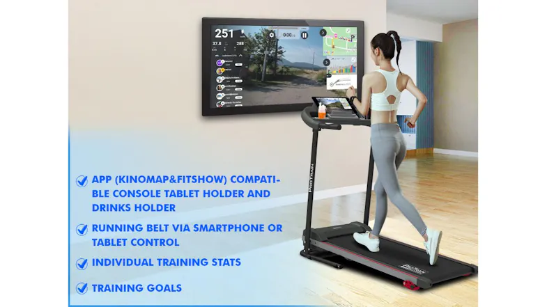 A person using a compact treadmill at home, facing a large screen with fitness app data and workout features listed A person using a compact treadmill at home, facing a large screen with fitness app data and workout features listed