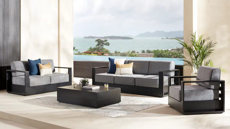 Outdoor setting featuring the Monaco furniture collection, including a sofa, two armchairs, and a table. Outdoor setting featuring the Monaco furniture collection, including a sofa, two armchairs, and a table.
