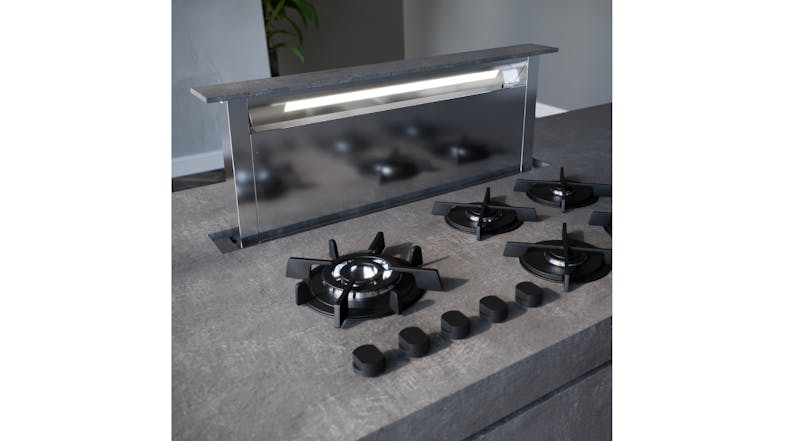 Black integrated downdraft rangehood raised behind a gas cooktop, actively capturing cooking fumes Black integrated downdraft rangehood raised behind a gas cooktop, actively capturing cooking fumes