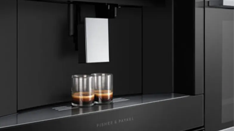 Dispensing area of the coffee machine with three glasses placed underneath. Dispensing area of the coffee machine with three glasses placed underneath.