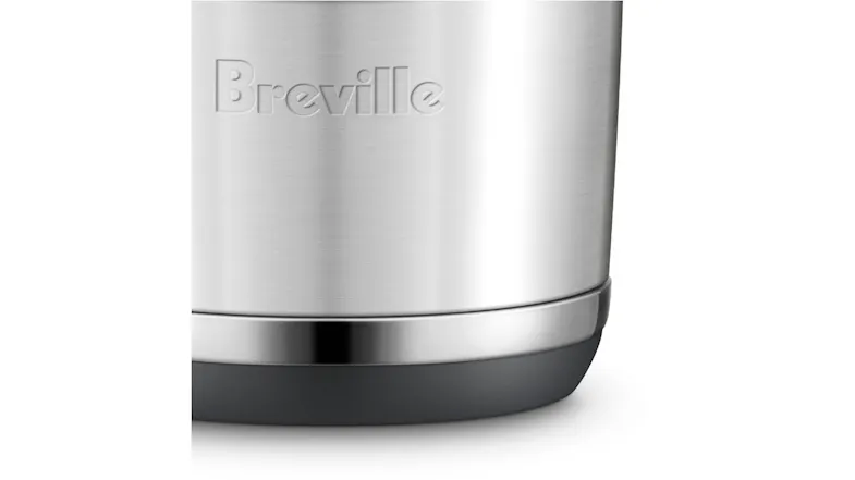 Close-up of the Breville logo on a stainless steel knock box with silver trim and a black base Close-up of the Breville logo on a stainless steel knock box with silver trim and a black base