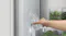 A view of a hand filling a glass of water via the unit's dispenser A view of a hand filling a glass of water via the unit's dispenser