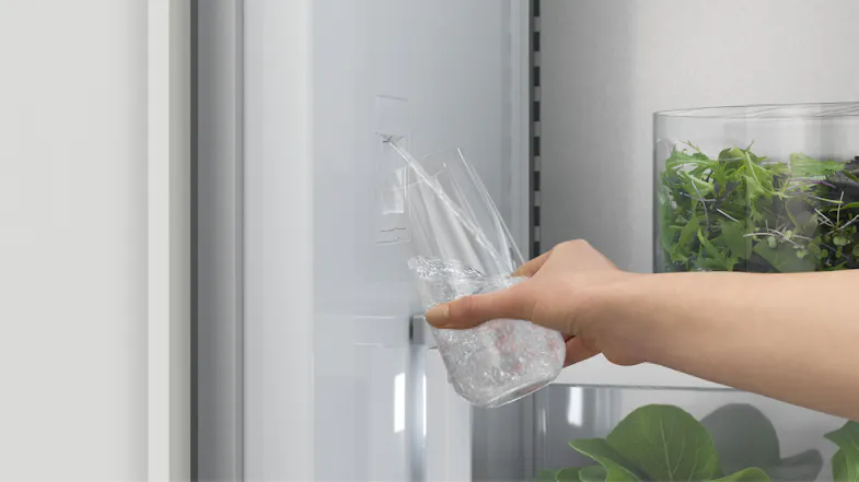 A view of a hand filling a glass of water via the unit's dispenser A view of a hand filling a glass of water via the unit's dispenser
