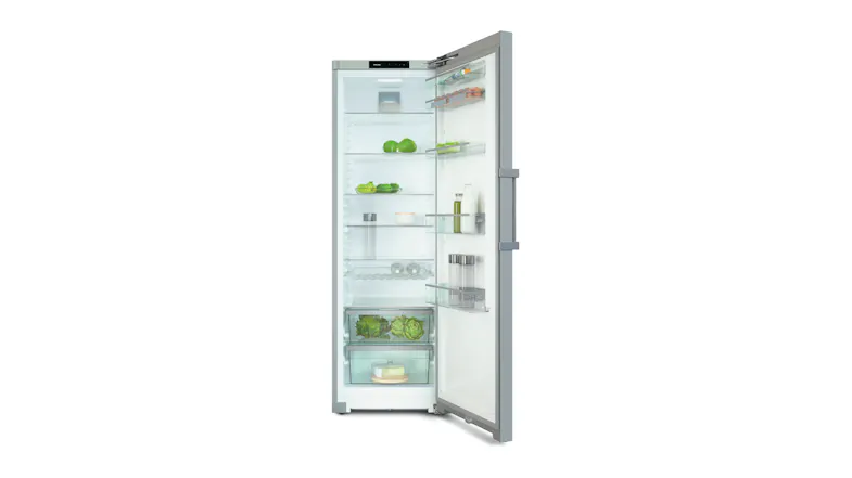 Open Miele fridge with glass shelves and door racks, storing vegetables, bottles, and jars under LED lighting Open Miele fridge with glass shelves and door racks, storing vegetables, bottles, and jars under LED lighting