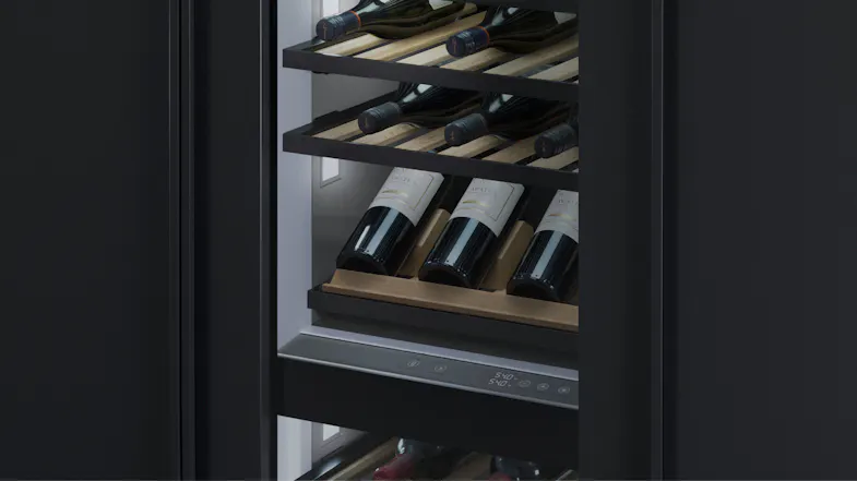 Close-up of wine bottles stored on wooden shelves inside Fisher & Paykel wine fridge, with digital control panel visible. Close-up of wine bottles stored on wooden shelves inside Fisher & Paykel wine fridge, with digital control panel visible.