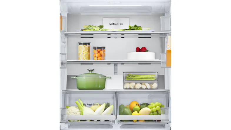 Close-up of fridge’s upper section with Multi Air Flow panel, glass shelves holding vegetables, fruits, and a cake Close-up of fridge’s upper section with Multi Air Flow panel, glass shelves holding vegetables, fruits, and a cake