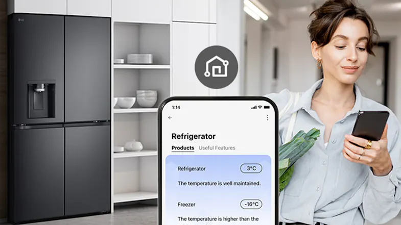 A person holding groceries while checking the refrigerator app on her phone A person holding groceries while checking the refrigerator app on her phone