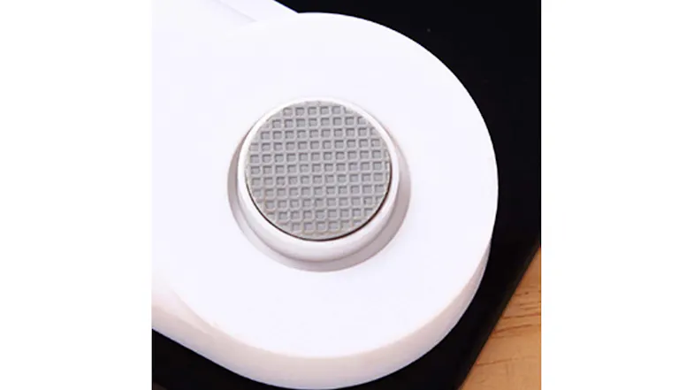 Close-up view of a scale's base with a rubber foot Close-up view of a scale's base with a rubber foot