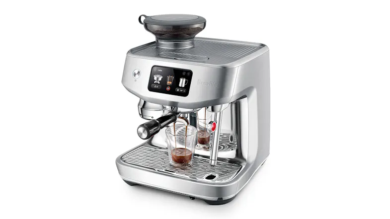 A Breville stainless steel espresso machine with digital controls and two glasses catching fresh espresso shots A Breville stainless steel espresso machine with digital controls and two glasses catching fresh espresso shots