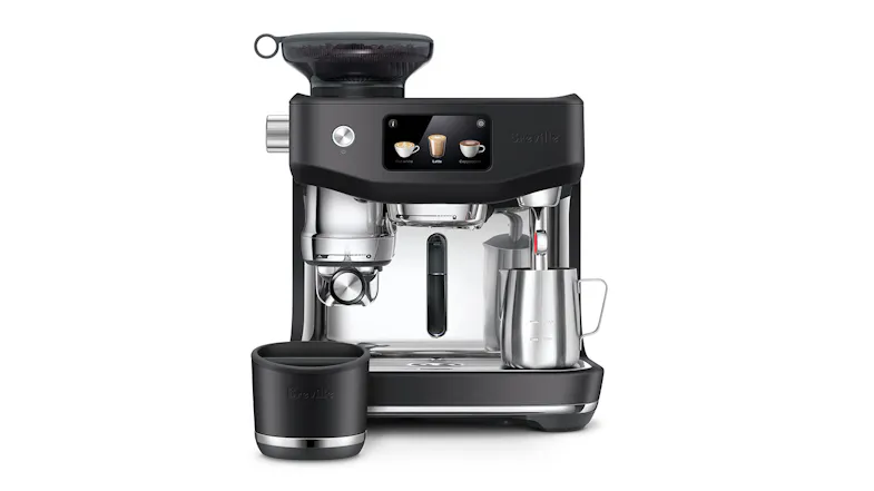 An espresso machine with a touchscreen, a portafilter, a steam wand, a milk pitcher, and a small cup beside it An espresso machine with a touchscreen, a portafilter, a steam wand, a milk pitcher, and a small cup beside it