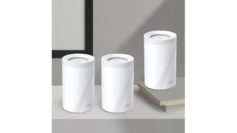 Three TP-Link Deco routers sits on a table. Three TP-Link Deco routers sits on a table.