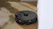 Roborock S8 robot vacuum docked in a sleek, self-emptying base station placed against a wooden wall in a modern room Roborock S8 robot vacuum docked in a sleek, self-emptying base station placed against a wooden wall in a modern room