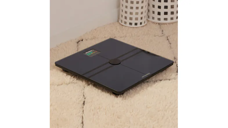 Body Comp Scale placed on a textured area rug Body Comp Scale placed on a textured area rug