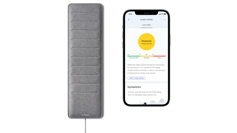 Withings sleep mat next to a phone showing Moderate Sleep Apnea results Withings sleep mat next to a phone showing Moderate Sleep Apnea results