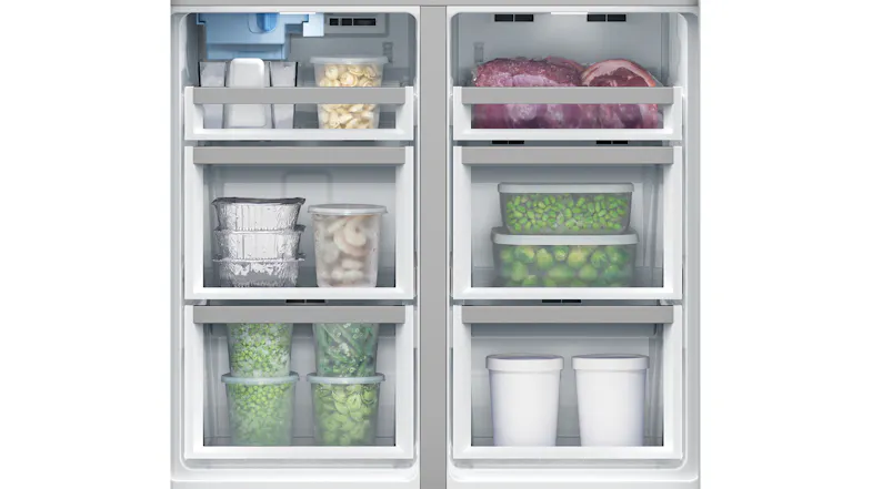 Freezer drawers of a fridge containing frozen meat, peas, ice cream, and food containers organised in compartments Freezer drawers of a fridge containing frozen meat, peas, ice cream, and food containers organised in compartments
