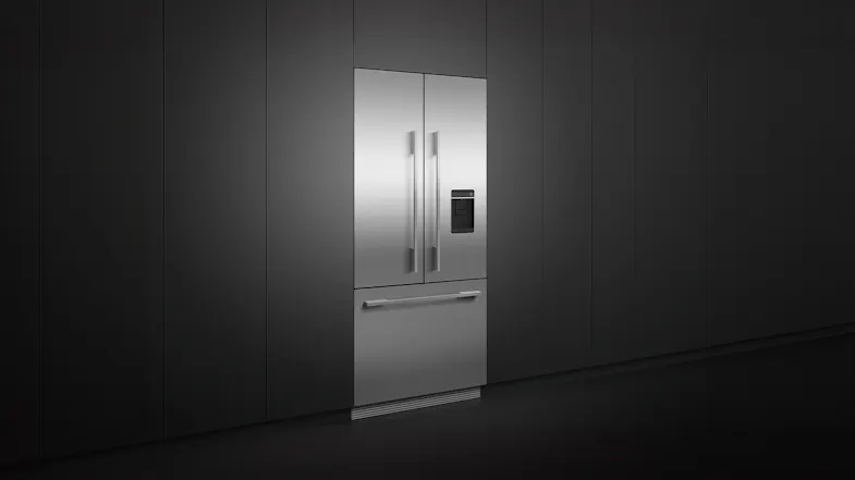The fridge freezer installed flush on a sleek black wall The fridge freezer installed flush on a sleek black wall