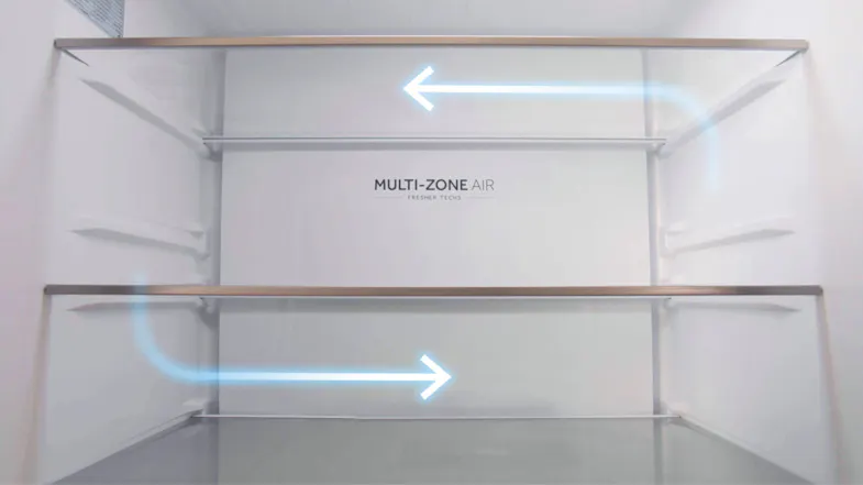 Interior view of a fridge showing Multi-Zone Air system with blue airflow arrows across glass shelves for even cooling Interior view of a fridge showing Multi-Zone Air system with blue airflow arrows across glass shelves for even cooling