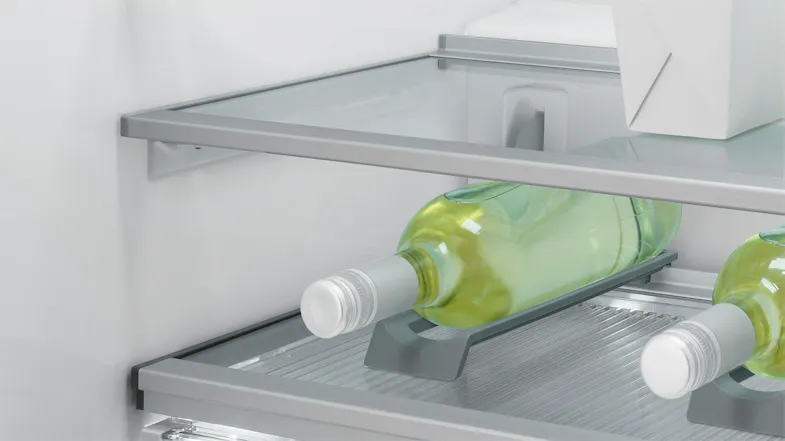 Close-up of a fridge shelf with two green wine bottles placed horizontally on a built-in bottle rack Close-up of a fridge shelf with two green wine bottles placed horizontally on a built-in bottle rack