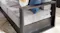 A black‑framed Monaco two‑seater outdoor sofa with grey seat and back cushions A black‑framed Monaco two‑seater outdoor sofa with grey seat and back cushions