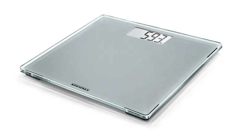 Grey bathroom weighing scale with LCD reading 59.3 kg Grey bathroom weighing scale with LCD reading 59.3 kg